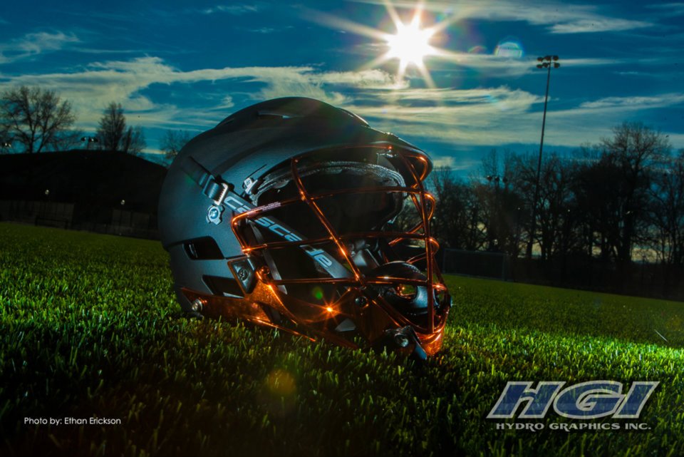 Oregon State LAX helmets featuring a black HydroSkin® shell and orange HydroChrome™ mask.